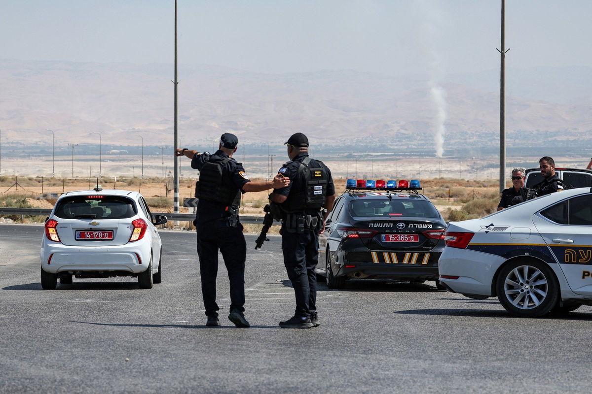 <i>Ahmad Gharabli/AFP/Getty Images via CNN Newsource</i><br/>Israeli security forces gather at the scene of the attack near the Allenby Crossing on Sunday.