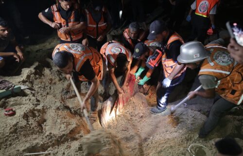 Teams conduct a search and rescue operation after Israeli airstrike on a tent encampment of displaced Palestinians in Al-Mawasi area of Khan Yunis