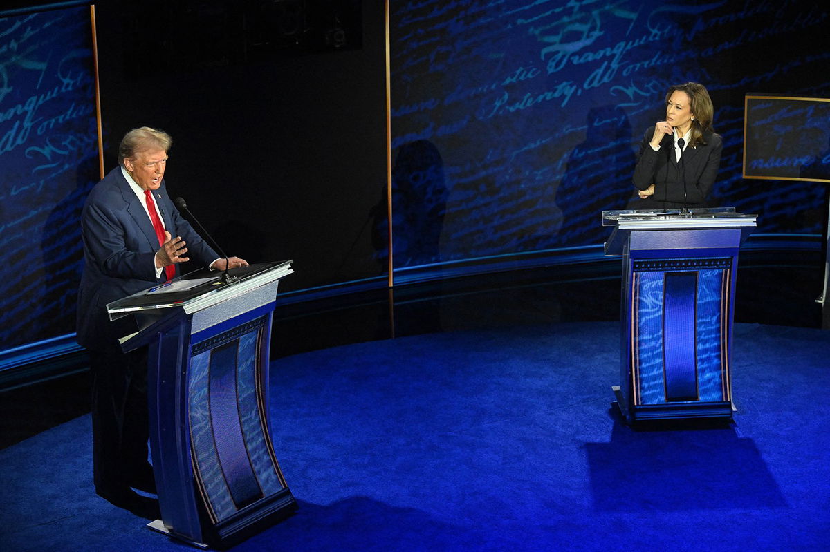 <i>Saul Loeb/AFP/Getty Images via CNN Newsource</i><br/>Kamala Harris listens as Donald Trump speaks during the ABC presidential debate in Philadelphia on Tuesday