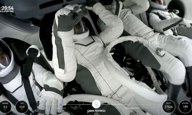 Polaris Dawn crew members are seen within the SpaceX Crew Dragon capsule.