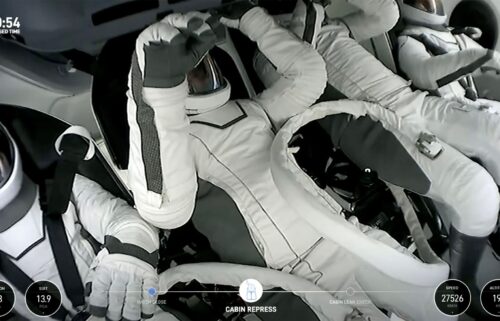 Polaris Dawn crew members are seen within the SpaceX Crew Dragon capsule.