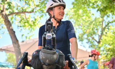 Lael Wilcox prepares to resume riding after taking a break in the Santa Fe Plaza on September 4.