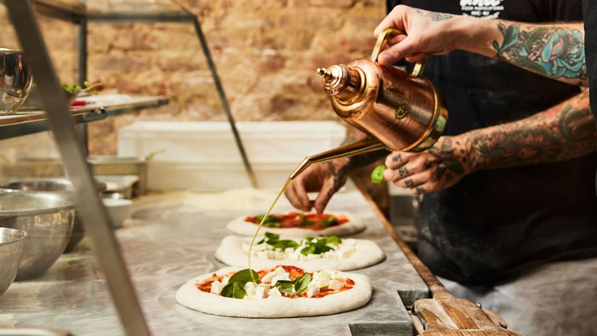 <i>Mark Weinberg via CNN Newsource</i><br/>The olive oil – and the praise – flows Una Pizza Napoletana in New York City.