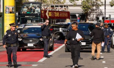 Police officers secure the area and investigate the scene of a shooting at Union Square in San Francisco on August 31.