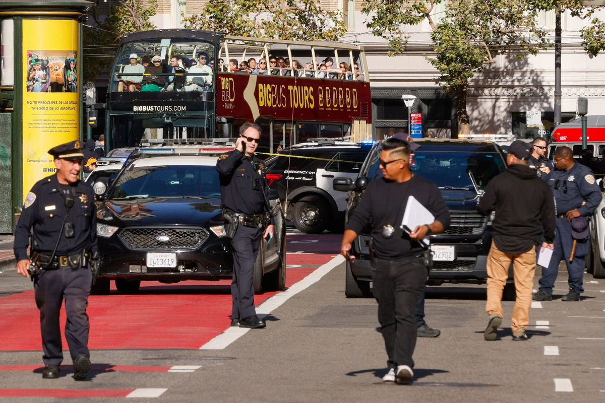 <i>Santiago Mejia/San Francisco Chronicle/Getty Images via CNN Newsource</i><br/>Police officers secure the area and investigate the scene of a shooting at Union Square in San Francisco on August 31.