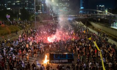 Israeli protestors block the Ayalon freeway during a mass protest in Tel Aviv