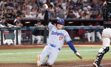 Ohtani safely slides at home plate to score a run during the eighth inning against the Arizona Diamondbacks.