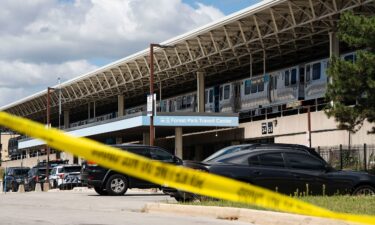 Yellow tape blocks off the parking lot of the Forest Park Blue Line train station in Forest Park