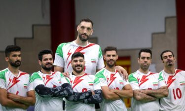 Morteza Mehrzadselakjani (top center) poses for a picture with his Iranian teammates during a training session of the men's sitting volleyball team ahead of the 2024 Paralympics Paris Games.