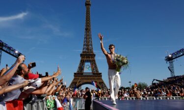 Medallists parade in front of the Eiffel Tower during the Games.