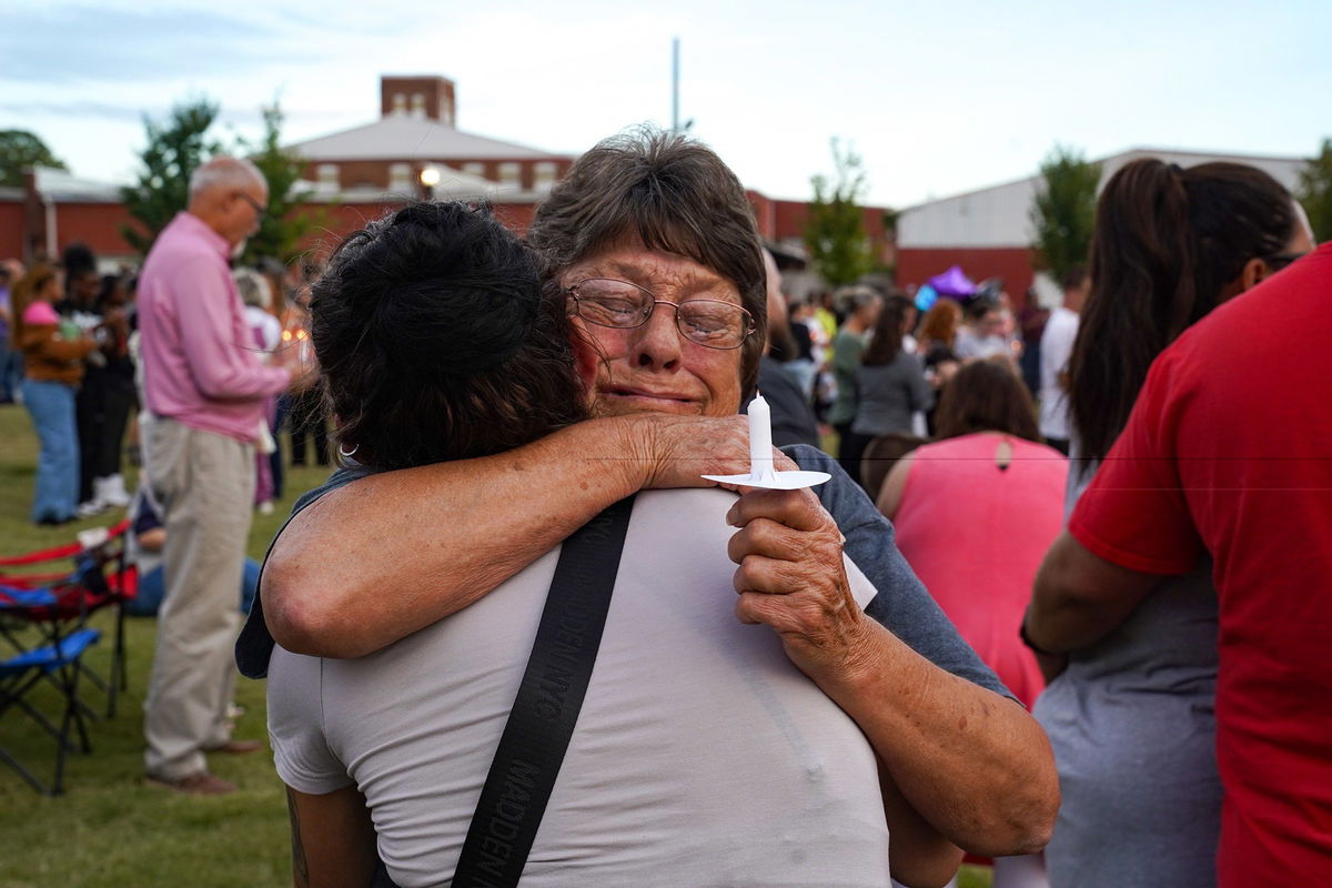 <i>Megan Varner/Getty Images via CNN Newsource</i><br/>Two women embrace as students