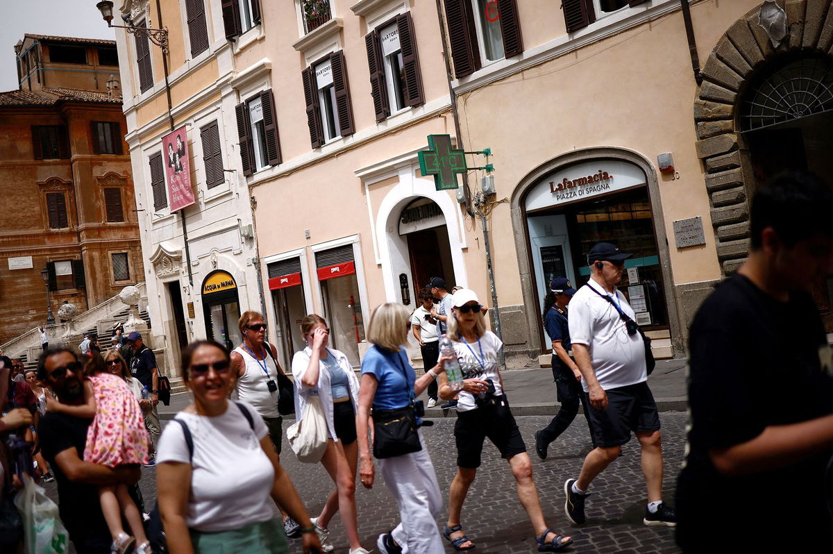 <i>Guglielmo Mangiapane/Reuters via CNN Newsource</i><br/>A pharmacy sign displays a temperature of 41 degrees Celsius (105.8 Fahrenheit) at the Spanish Steps amid a heatwave