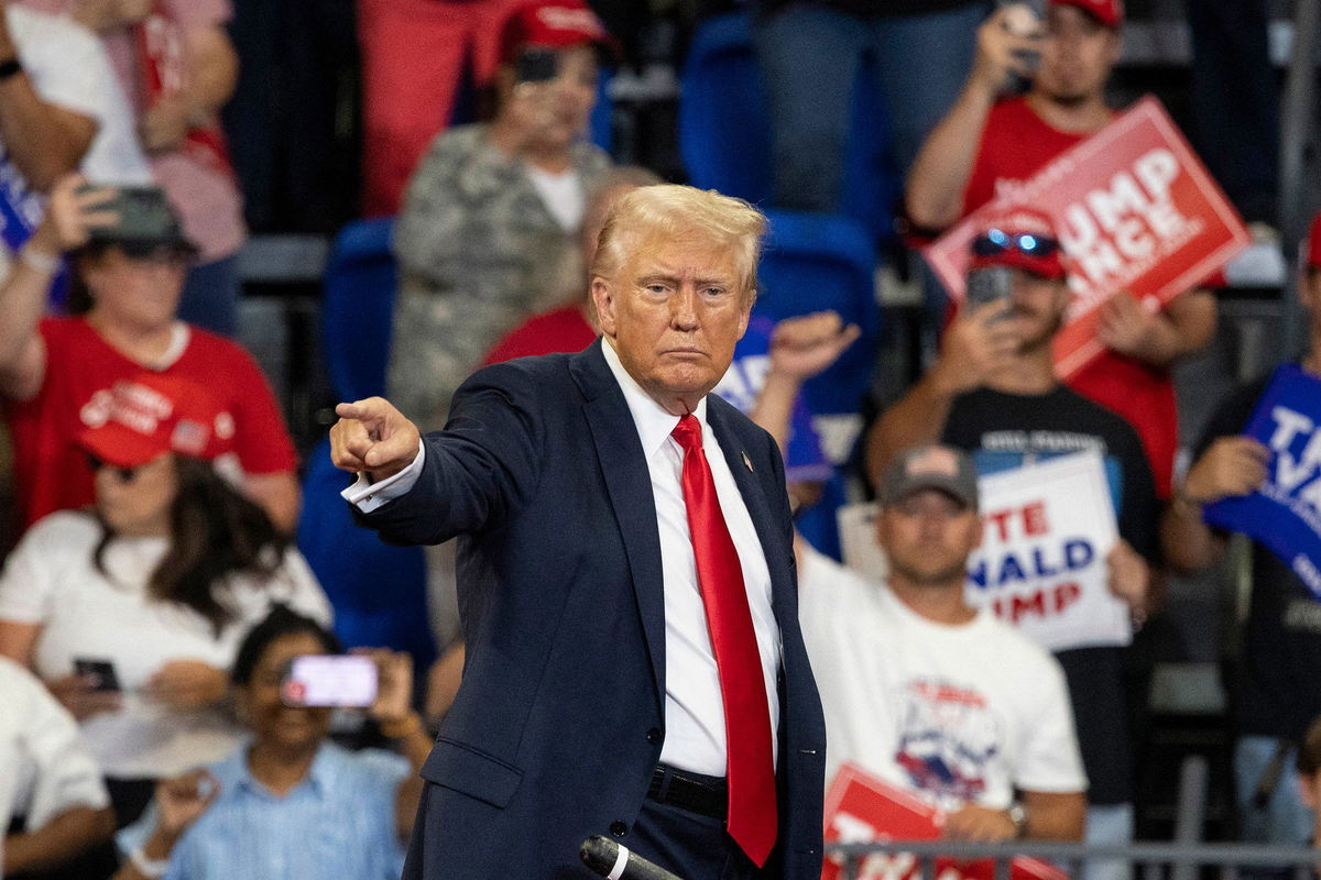 <i>Christian MonterrosaA/AFP/Getty Images/File via CNN Newsource</i><br/>Former President Donald Trump points to the crowd as he leaves after a campaign rally at the Georgia State Convocation Center in Atlanta on August 3.