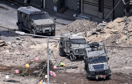 Israeli army armoured vehicles move along an excavated section of a road in the centre of Jenin in the occupied West Bank amid ongoing military operations in the Palestinian territories.