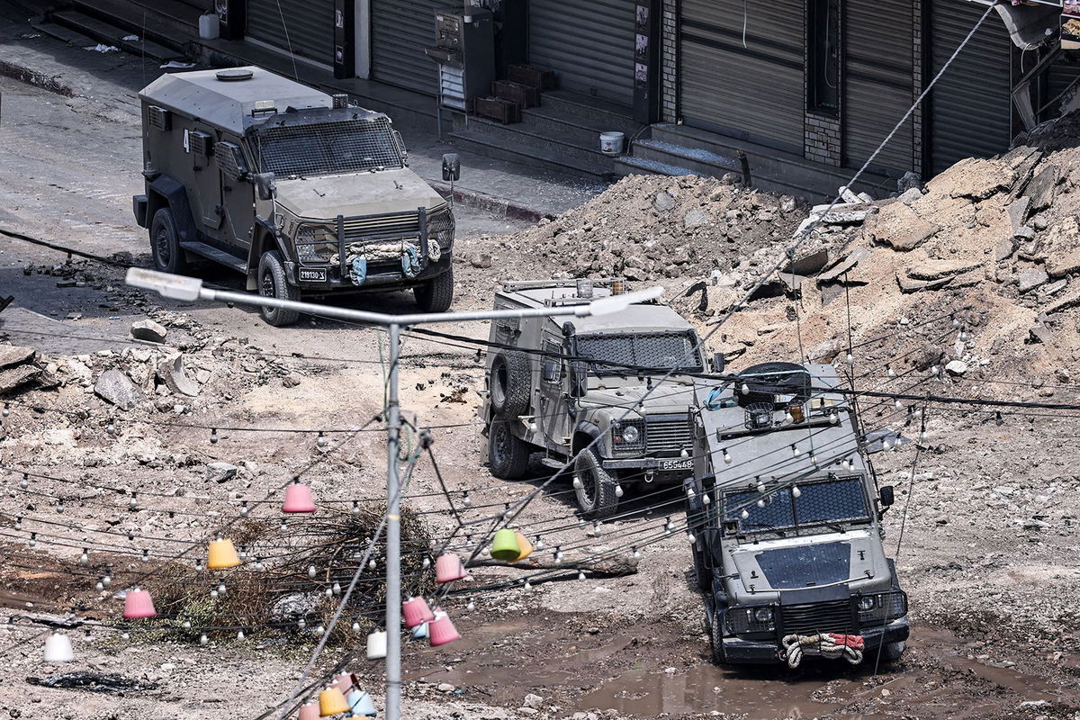 <i>Zain Jaafar/AFP/Getty Images via CNN Newsource</i><br/>Israeli army armoured vehicles move along an excavated section of a road in the centre of Jenin in the occupied West Bank amid ongoing military operations in the Palestinian territories.