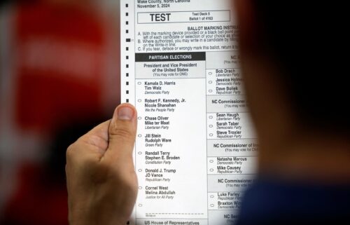 An election worker displays a test ballot listing the US presidential candidates at the Wake County Board of Elections headquarters in Raleigh