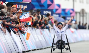 Oksana Masters celebrates winning during the women's H5 road race at of the 2024 Paris Paralympic Games.