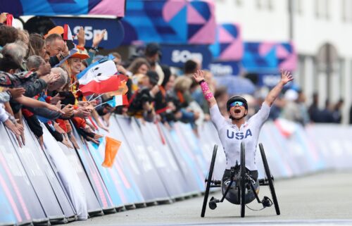 Oksana Masters celebrates winning during the women's H5 road race at of the 2024 Paris Paralympic Games.