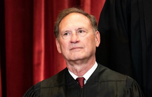 Associate Justice Samuel Alito sits during a group photo of the justices at the Supreme Court in Washington