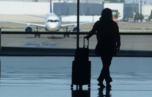 A holiday traveler looks out at an airplane at Salt Lake City International Airport over the July 4 holiday weekend. Frequent flyer programs have become a crucial part of the airline industry’s profitability.