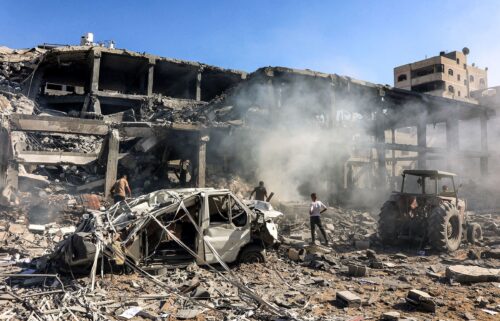 Men walk through debris in a building that was hit by Israeli bombardment in the Sheikh Radwan neighbourhood in the north of Gaza City on September 3.