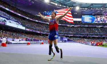 Team USA's Hunter Woodhall celebrates after winning gold at the Paris 2024 Paralympics.