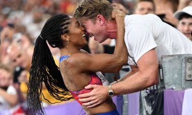 Tara Davis-Woodhall celebrates with her husband Hunter Woodhall after winning the Olympic title in the women's long jump at the 2024 Paris Games.