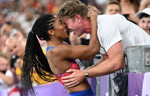 Tara Davis-Woodhall celebrates with her husband Hunter Woodhall after winning the Olympic title in the women's long jump at the 2024 Paris Games.