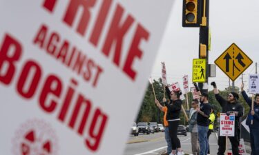 Workers with picket signs outside the Boeing Co. manufacturing facility.