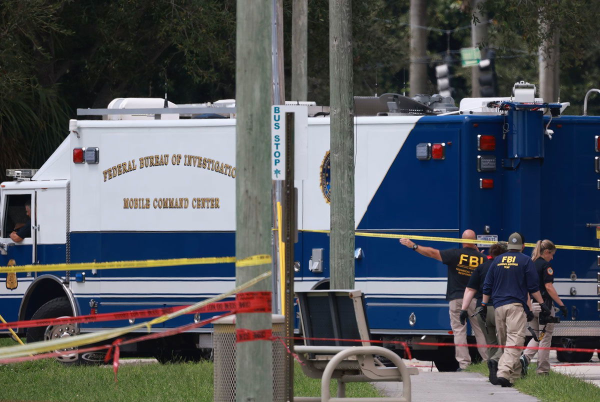 <i>Joe Raedle/Getty Images via CNN Newsource</i><br/>Law enforcement personnel continue to investigate the area around Trump International Golf Club after an apparent assassination attempt on former President Donald Trump on September 16 in West Palm Beach