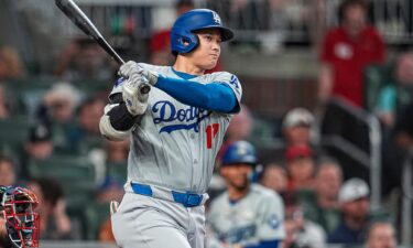 Los Angeles Dodgers designated hitter Shohei Ohtani doubles to drive in a run against the Atlanta Braves during the fifth inning at Truist Park.