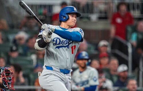 Los Angeles Dodgers designated hitter Shohei Ohtani doubles to drive in a run against the Atlanta Braves during the fifth inning at Truist Park.