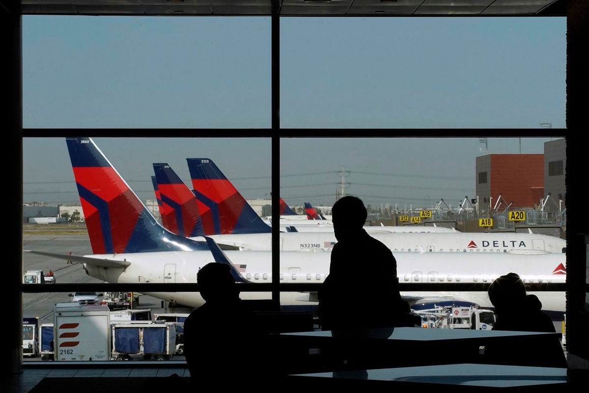 <i>George Frey/Bloomberg/Getty Images/FILE via CNN Newsource</i><br/>Delta Air Lines planes sit at gates at Salt Lake City International Airport in a 2020 file photo.