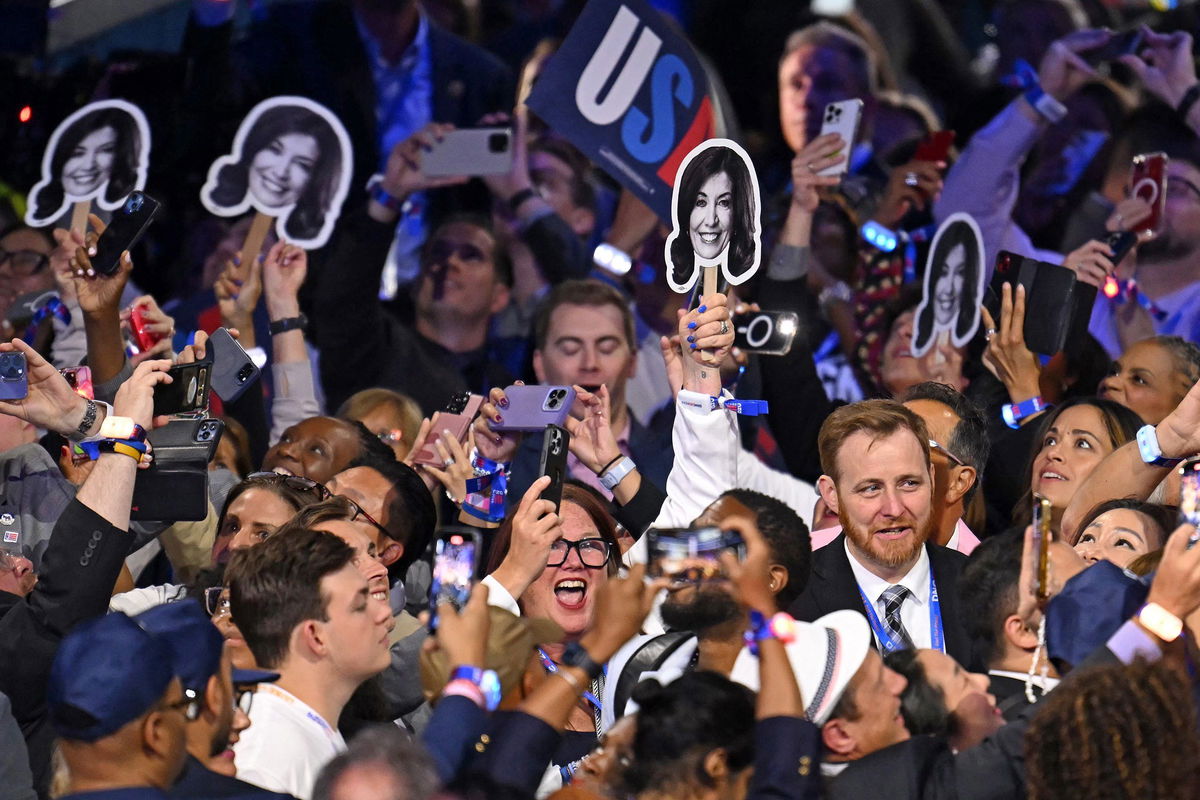 <i>Andrew Caballero-Reynolds/AFP/Getty Images/File via CNN Newsource</i><br/>Members of the New York delegation hold pictures of Hochul during the ceremonial roll call vote at the Democratic National Convention in Chicago on August 20.