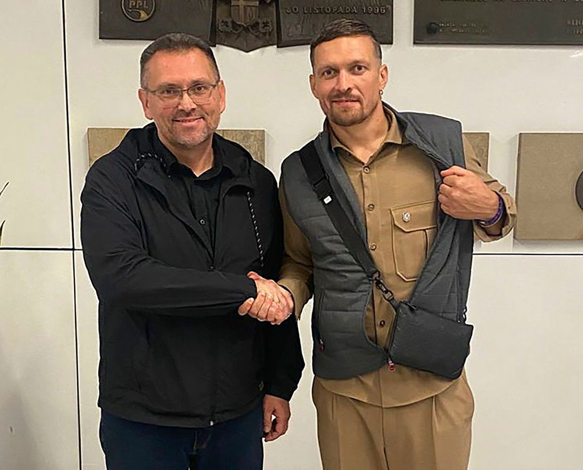 <i>Ukrainian Presidential Office/AP via CNN Newsource</i><br/>Heavyweight boxing champion Oleksandr Usyk (right) shakes hands with the Ukrainian Consul General in Krakow