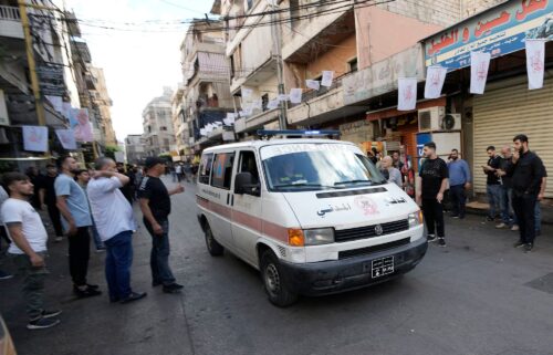 An ambulance drives through a southern suburb of Beirut after explosions were heard.