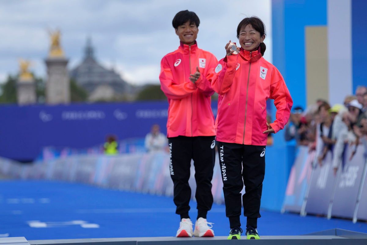 <i>Thibault Camus/AP via CNN Newsource</i><br/>Japan's Misato Michishita poses with her bronze medal after the race.