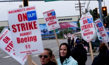 Boeing workers wave picket signs as they strike on September 15