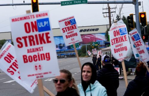 Boeing workers wave picket signs as they strike on September 15