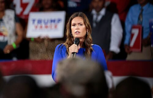 Arkansas Gov. Sarah Huckabee Sanders moderates a town hall meeting with former President Donald Trump in Flint