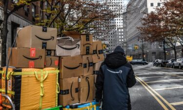 An Amazon worker delivers packages on Cyber Monday in New York on Monday