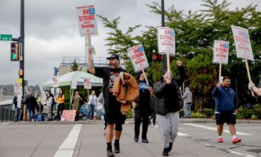 Striking workers and their supporters picket outside the Boeing manufacturing facility in Renton