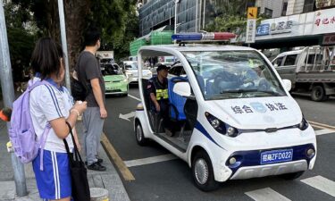 Security personnel stand guard near the site of a knife attack near a Japanese school in Shenzhen