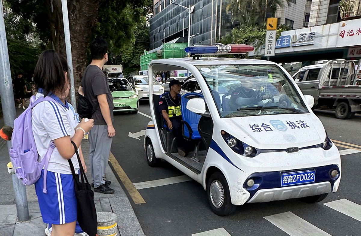 <i>The Yomiuri Shimbun/AP via CNN Newsource</i><br/>Security personnel stand guard near the site of a knife attack near a Japanese school in Shenzhen