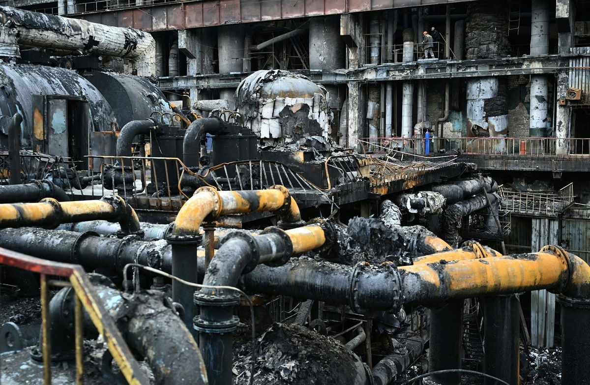 <i>Genya Savilov/AFP/Getty Images via CNN Newsource</i><br/>Workers remove debris in a turbine hall full of scorched equipment at a power plant in Ukraine in April 2024.