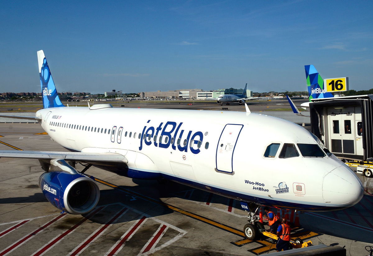 <i>Robert Alexander/Getty Images/FILE via CNN Newsource</i><br/>A JetBlue Airways plane is serviced at a gate at John F. Kennedy International Airport in a file photo.