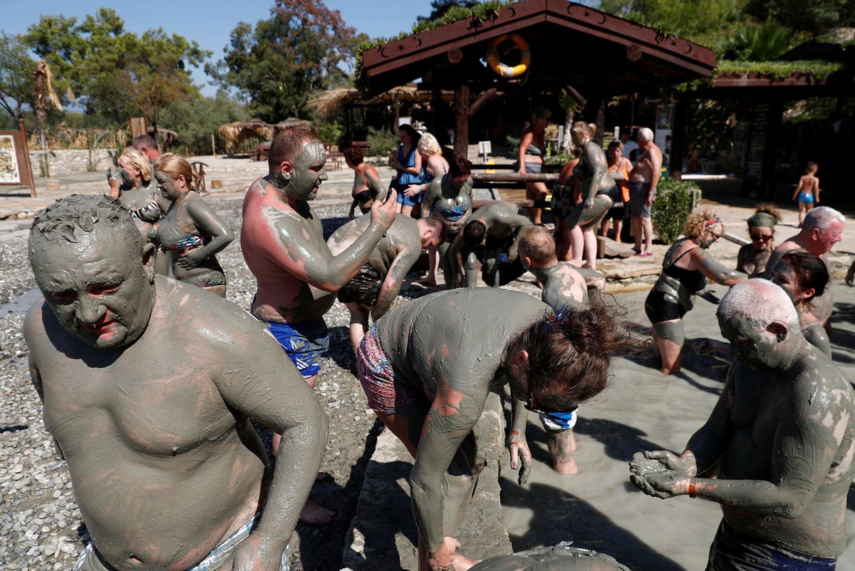 <i>Murad Sezer/Reuters via CNN Newsource</i><br/>Tourists flock to Dalyan's mud baths to rejuvenate their skin.