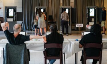 A Fulton County Elections worker stretches his arms as voters cast ballots in Georgia's primary election at a polling location in Atlanta on May 21.