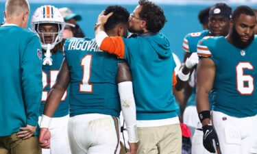 Miami Dolphins head coach Mike McDaniel embraces Tua Tagovailoa as he leaves the field after suffering a concussion against the Buffalo Bills.