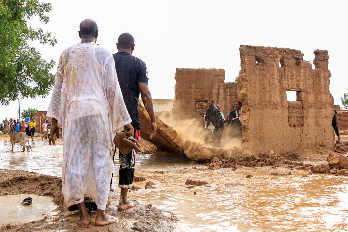 <i>AFP/Getty Images via CNN Newsource</i><br/>Men bring down the mudbrick wall of a house to act as a make-shift levee amidst flooding in the area of Messawi near Meroe in Sudan's Northern State on August 27.